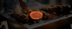 Grilling chicken background with an icon of a cast iron